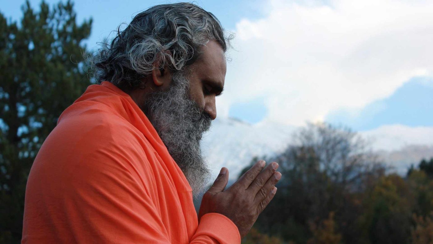 Old Indian man praying in the nature